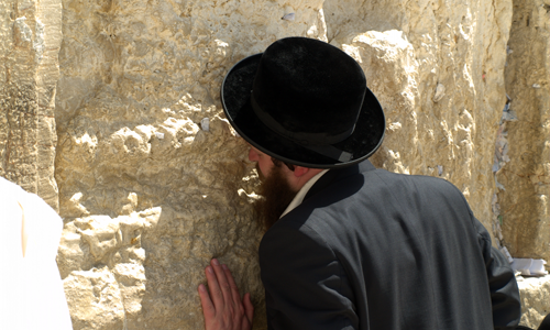 A_man_prays_at_the_Western_Wall_in_Jerusalem